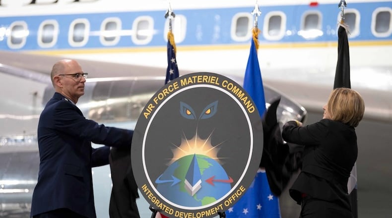 Gen. Duke Z. Richardson, left, then the Air Force Materiel Command commander, and Amanda Gentry, AFMC Integrated Development Office director, unveil the IDO emblem during the AFMC IDO Stand-up ceremony at the National Museum of the U.S. Air Force December 17, 2024. Air Force photo by Brian Dietrick