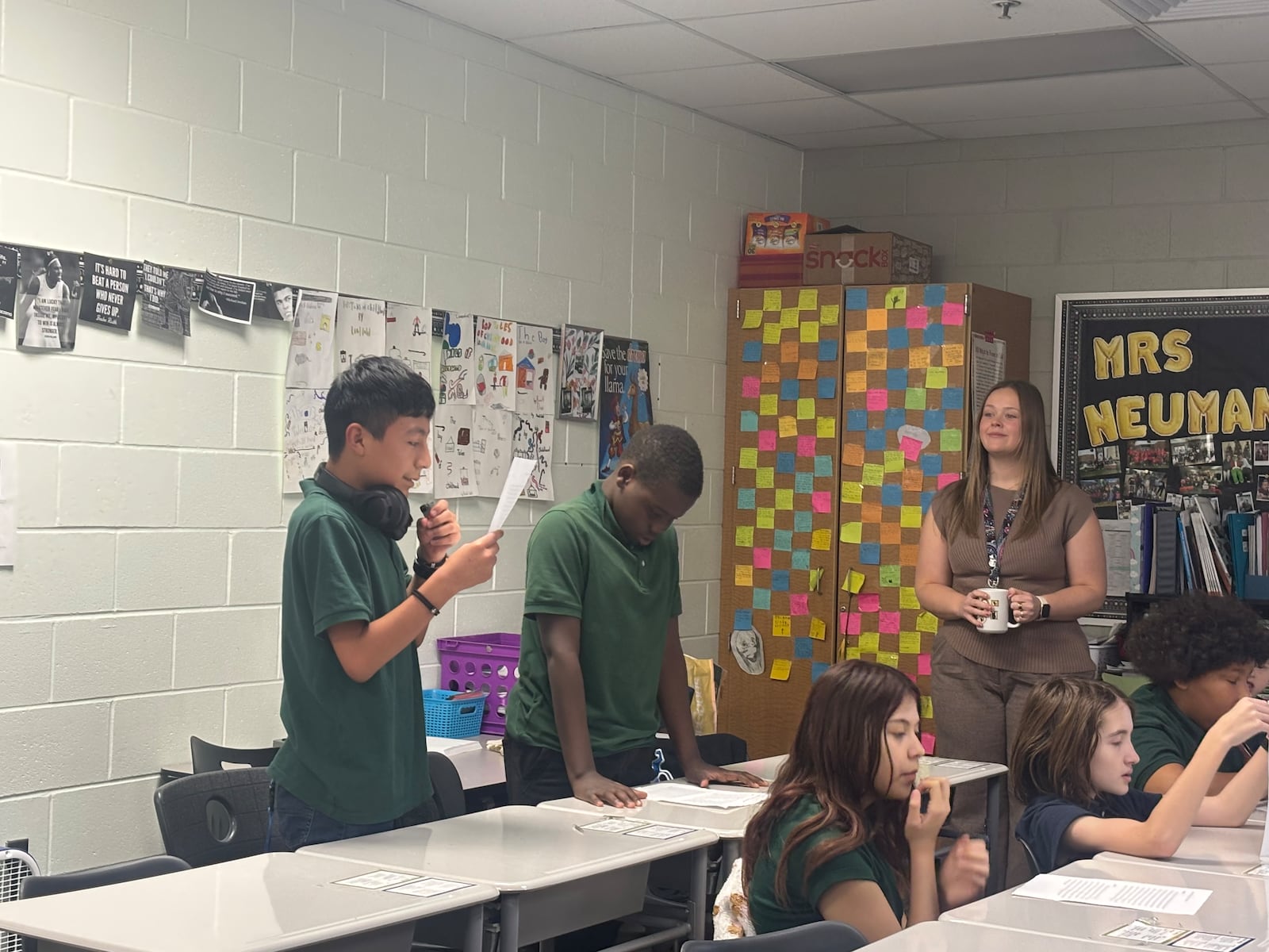 Students in Mrs. Neumann's sixth grade class at Cleveland Elementary read debate points during a class debate over chocolate being included in school lunches. Eileen McClory / staff