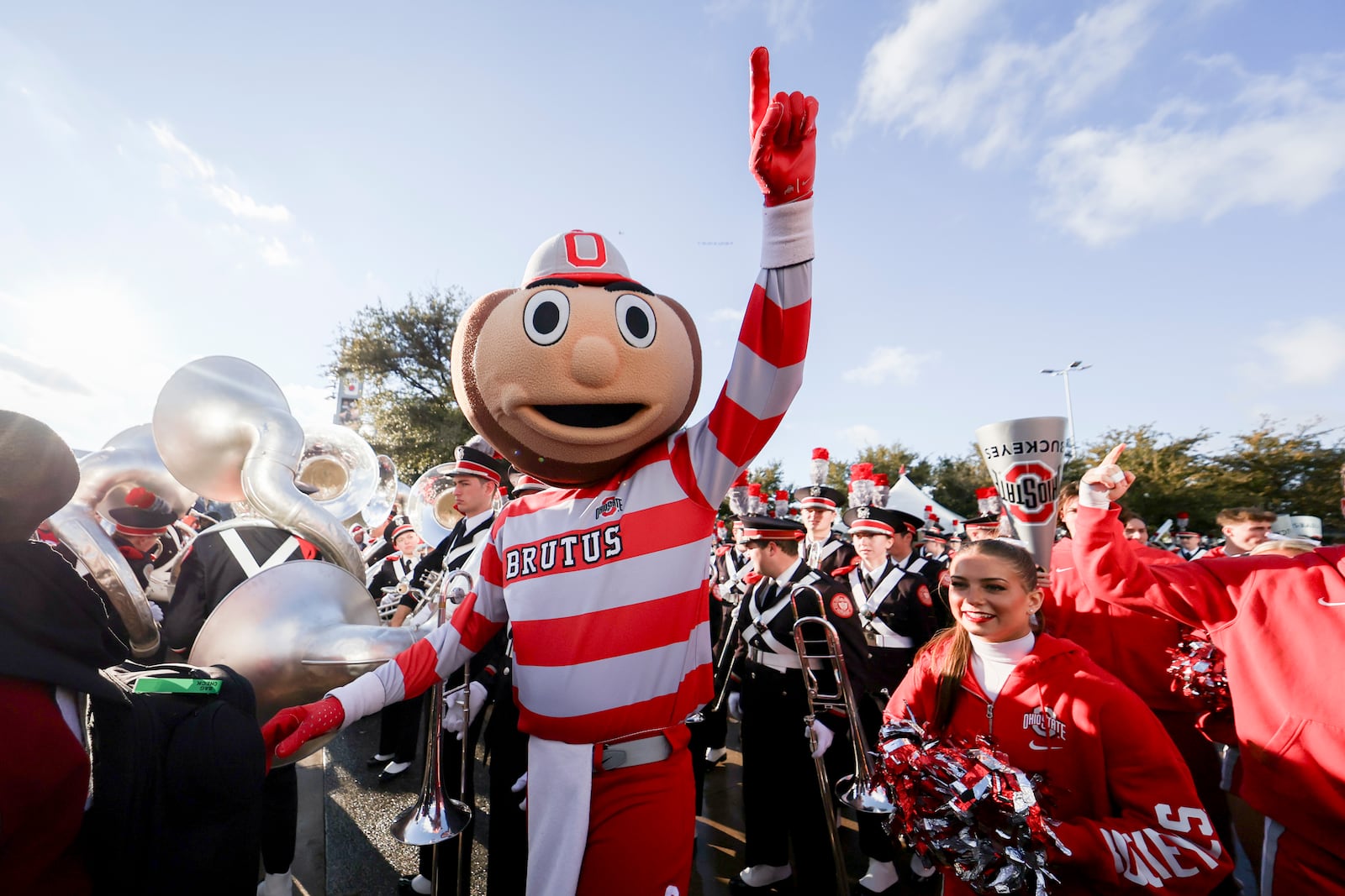 FILE - Brutus, the Ohio State mascot, stands with members of the band outside AT&T Stadium prior to the Cotton Bowl College Football Playoff semifinal game against Texas, Jan. 10, 2025, in Arlington, Texas. (AP Photo/Gareth Patterson, File)