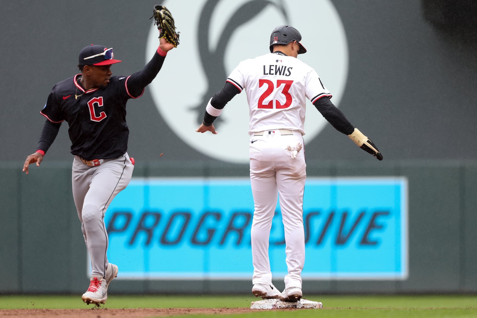 Cleveland Guardians second baseman Angel Martínez (1) gets an out on Minnesota Twins designated hitter Royce Lewis (23) during the fifth inning of a baseball game that was suspended Monday because of rain and resumed, Wednesday, May 21, 2025, in Minneapolis. (AP Photo/Ellen Schmidt)