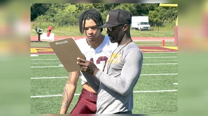 Santonio Holmes – the former Ohio State star receiver and NFL veteran who was named the MVP of Super Bowl XLIII after his game-winning TD catch for the Pittsburgh Steelers against Arizona – is now the new wide receivers coach at Central State. After the Marauders’ first day of practice Wednesday, he spent a good while mentoring former Trotwood Madison star receiver Quinten Johnson, who was a redshirt freshman at Illinois State last season, and transferred to CSU this year. TOM ARCHDEACON / CONTRIBUTED PHOTO