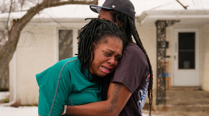 A family member reacts after federal immigration officers make an arrest Sunday, Jan. 11, 2026, in Minneapolis. (AP Photo/John Locher)