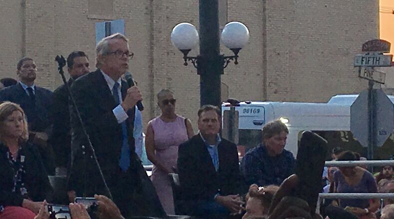 Gov. Mike DeWine speaks at a vigil for victims and survivors of the August 2019 shooting in Dayton’s Oregon District. The governor was met with shouts of “Do something” from the crowd, amid frustration over continuing mass shootings.