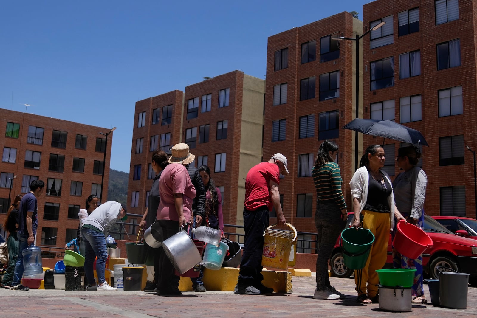 FILE - Residents line up to collect water from a truck during water rationing in La Calera, on the outskirts of Bogota, Colombia, April 16, 2024. (AP Photo/Fernando Vergara, File)