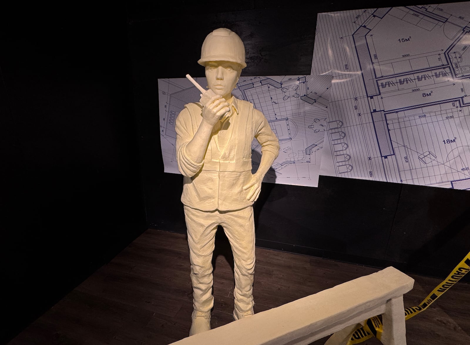 The butter display at the Ohio State Fair includes a construction worker on a two-way radio as part of the American Dairy Association Mideast’s butter cow display at the Ohio State Fair.