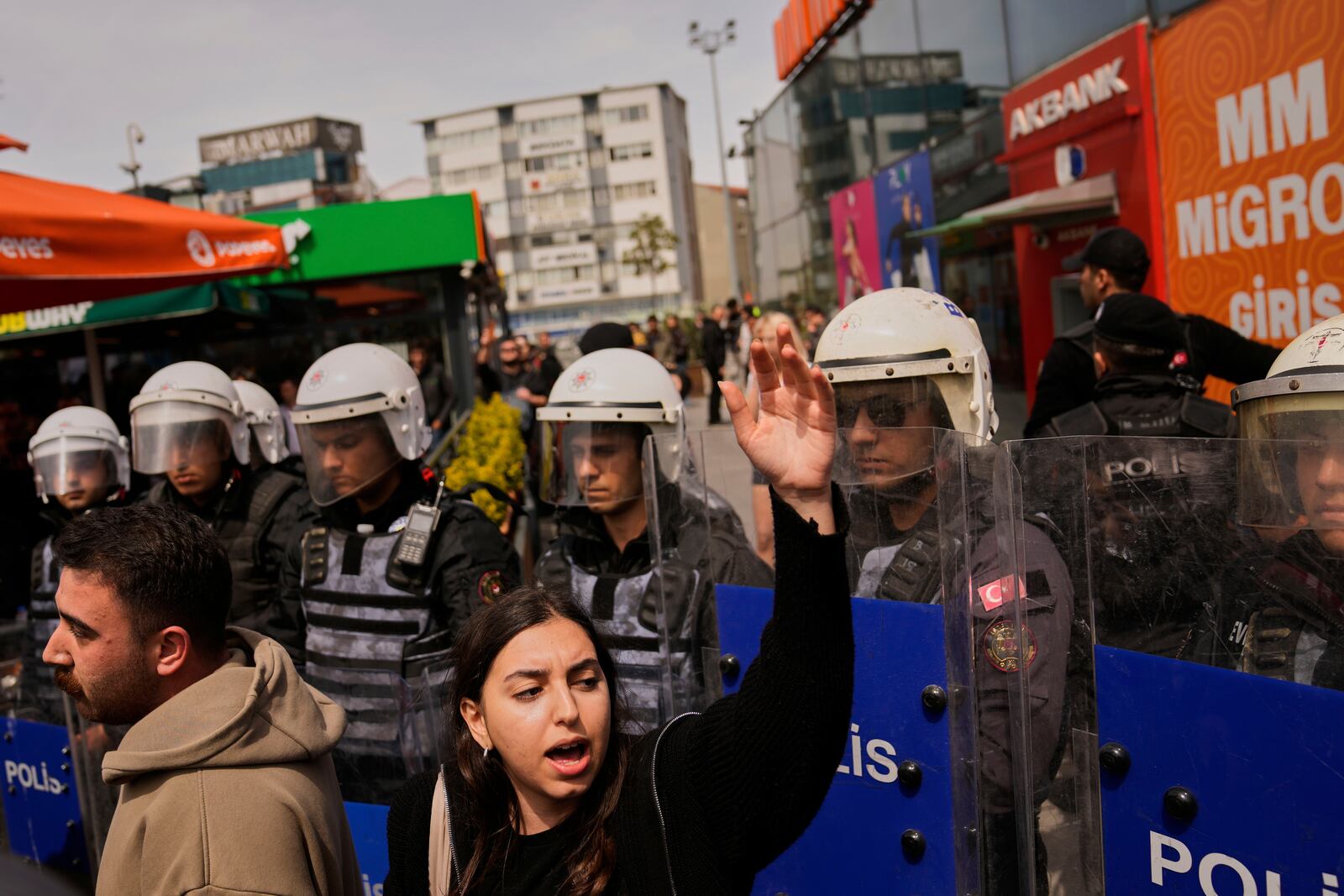 A woman shouts slogans during a protest outside Caglayan courthouse, in Istanbul, Turkey, Friday, April 18, 2025, during the hearing of dozens of people accused of attending banned demonstrations after the arrest of Istanbul's Mayor Ekrem Imamoglu. (AP Photo/Khalil Hamra)