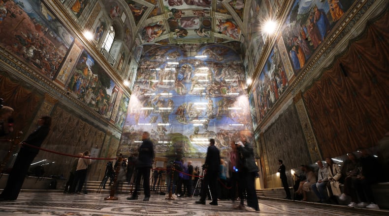 A screen with a replica of “The Last Judgment,” superimposed on it covers the scaffolding used for its extraordinary maintenance during a presentation for press in the Sistine Chapel at the Vatican, Saturday, Feb. 28, 2026. (AP Photo/Alessandra Tarantino)