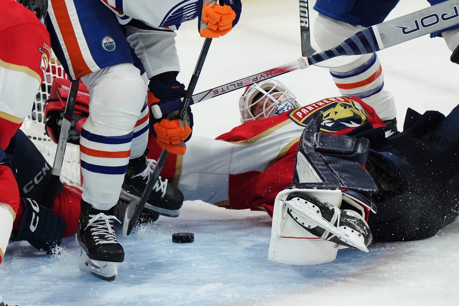 Florida Panthers goalie Sergei Bobrovsky, front right, makes a save against the Edmonton Oilers during the first overtime period in Game 4 of the NHL hockey Stanley Cup Final in Sunrise, Fla., Thursday, June 12, 2025. (Nathan Denette/The Canadian Press via AP)
