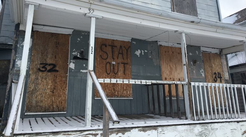 Vacant properties remain a problem in many Dayton neighborhoods. CORNELIUS FROLIK / STAFF