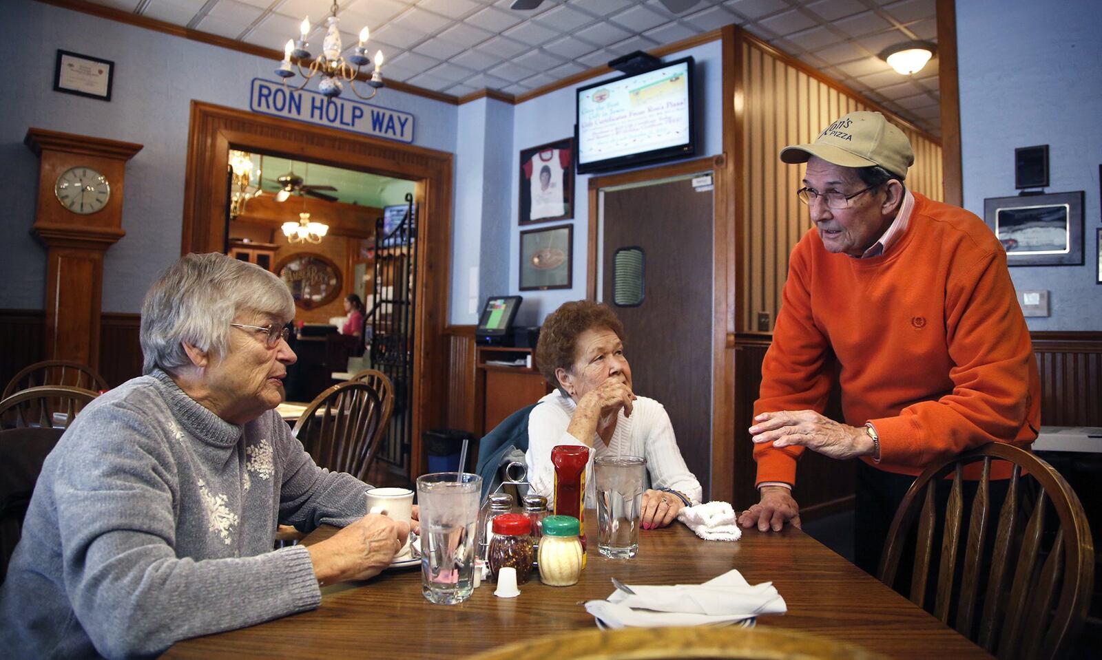 Ron Holp, the proprietor of Ron’s Pizza and Ribs, has been making pizza for 42 years. He started Dayton’s first “Pizza War” when he left Cassano’s to start his own pizza place On St. Patrick’s Day, 1964, he and his late wife Abbie opened Ron’s Pizza on North 12th Street in Miamisburg. Holp talks with friends and patrons Elaine Stuck, left, and Mary Ann Mote. TY GREENLEES / STAFF