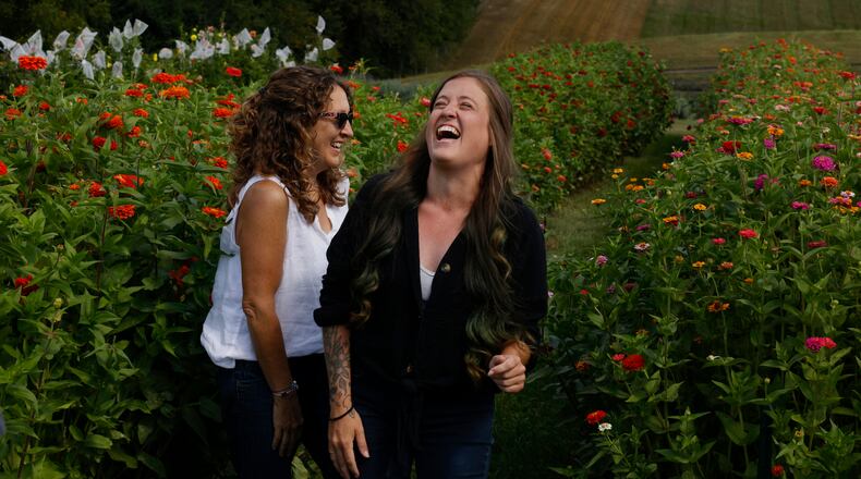 Farm owners Lydia Kristoff and her mother Jennifer Roberts laugh when talking about Bloomfield Farm's U-pick flower farm on Monday, August 25, 2025, in Springfield. JOSEPH COOKE/STAFF