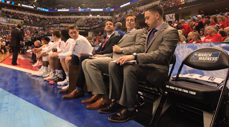Dayton's Brian Frank, center, Brian Walsh and Ben Sander, right, watch the action from the bench during a NCAA tournament game against Wichita State on March 17, 2017, at Bankers Life Fieldhouse in Indianapolis.