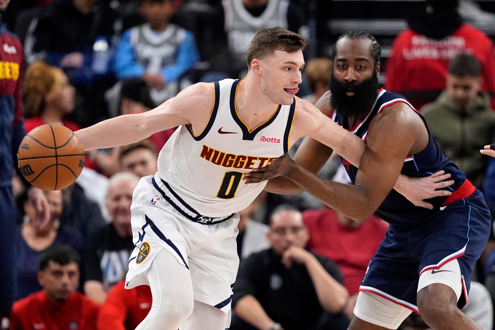 Denver Nuggets guard Christian Braun, left, tries to drive by Los Angeles Clippers guard James Harden, right, during the first half in Game 4 of an NBA basketball first-round playoff series Saturday, April 26, 2025, in Inglewood, Calif. (AP Photo/Mark J. Terrill)