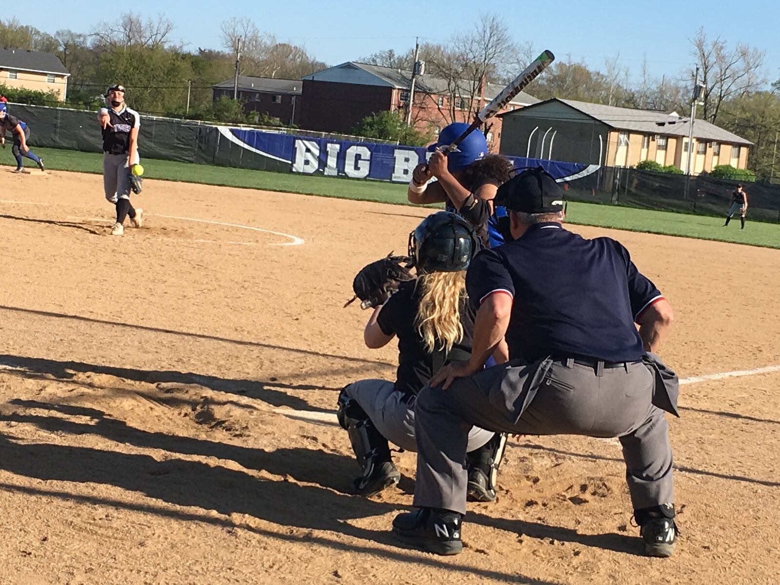 Middletown’s Carly Metcalf sends a pitch toward her catcher, Katie Pearson, and Hamilton’s Mya Halcomb (23) during an April 30 game at HHS. RICK CASSANO/STAFF