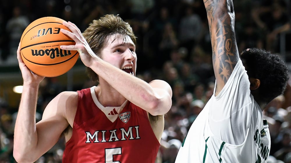 Miami (Ohio) guard Luke Skaljac (5) drives into Ohio forward Javan Simmons (1) during the second half of an NCAA college basketball game against Ohio, Friday, March 6, 2026, in Athens, Ohio. (AP Photo/HG Biggs)