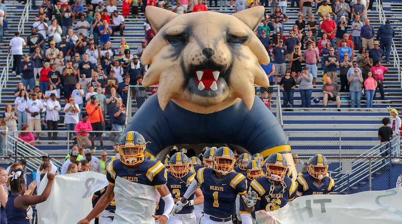 The Springfield High School football team runs onto the field for its Week 1 game against Lancaster at Evans Stadium earlier this season. The Wildcats face Hilliard Davidson in a Division I, Region 3 semifinal game at 7 p.m. Friday at London High School. CONTRIBUTED PHOTO BY MICHAEL COOPER