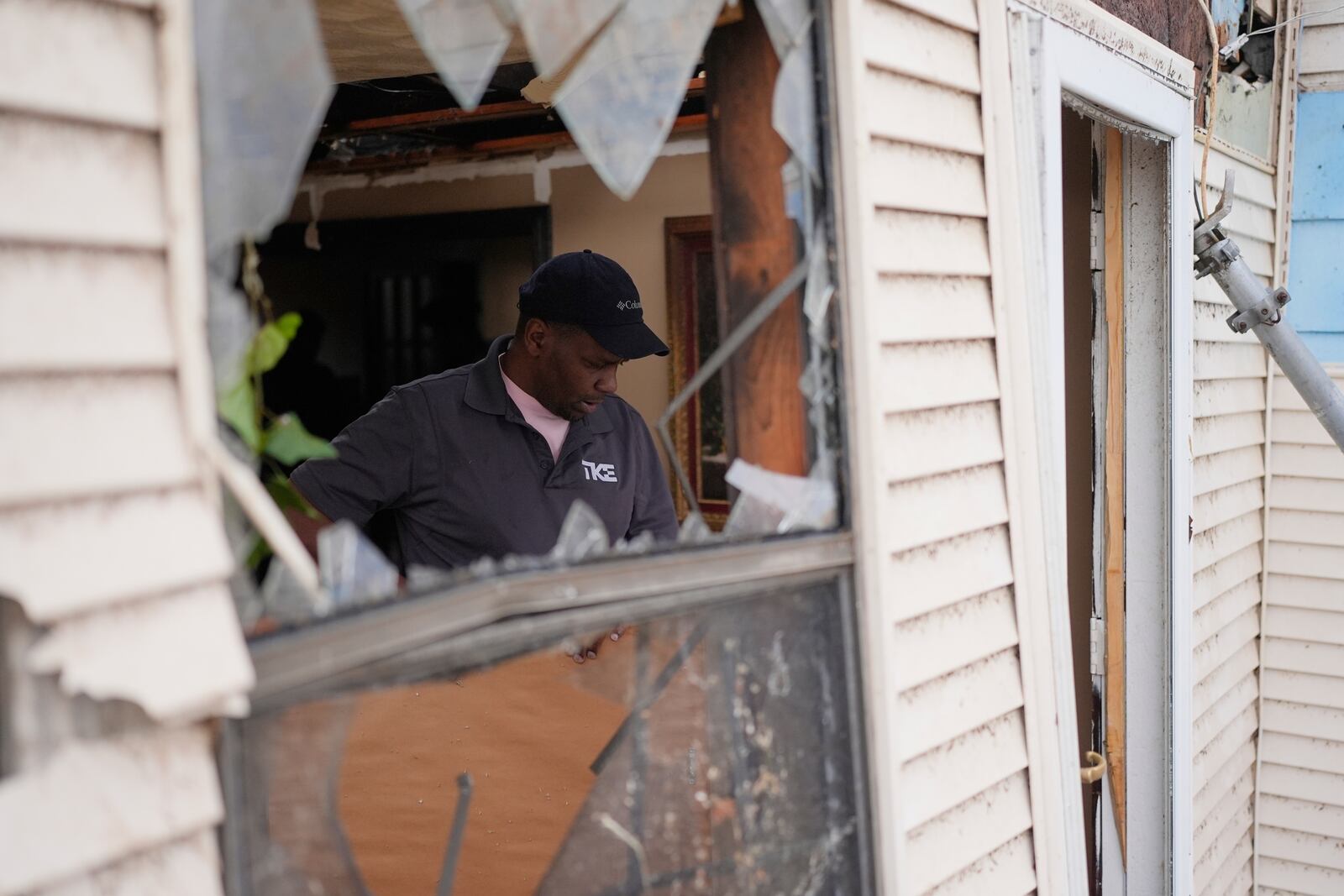 Jamar Atkins helps to clean up a house after severe weather passed the area in Selma, Tenn., Thursday, April 3, 2025. (AP Photo/George Walker IV)