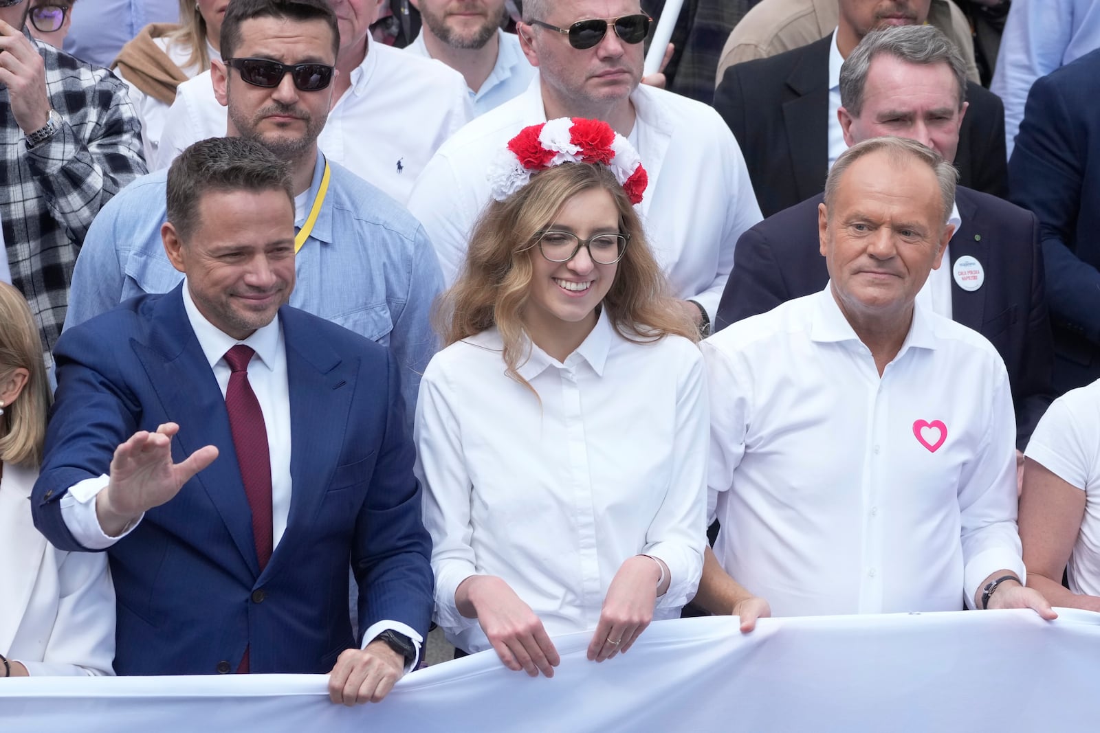 The liberal presidential candidate Rafal Trzaskowski, front left, waves as he and Polish prime minister Donald Tusk, front right, take part in a march one week ahead of a decisive presidential election in Warsaw, Poland on Sunday, May 25, 2025. (AP Photo/Czarek Sokolowski)