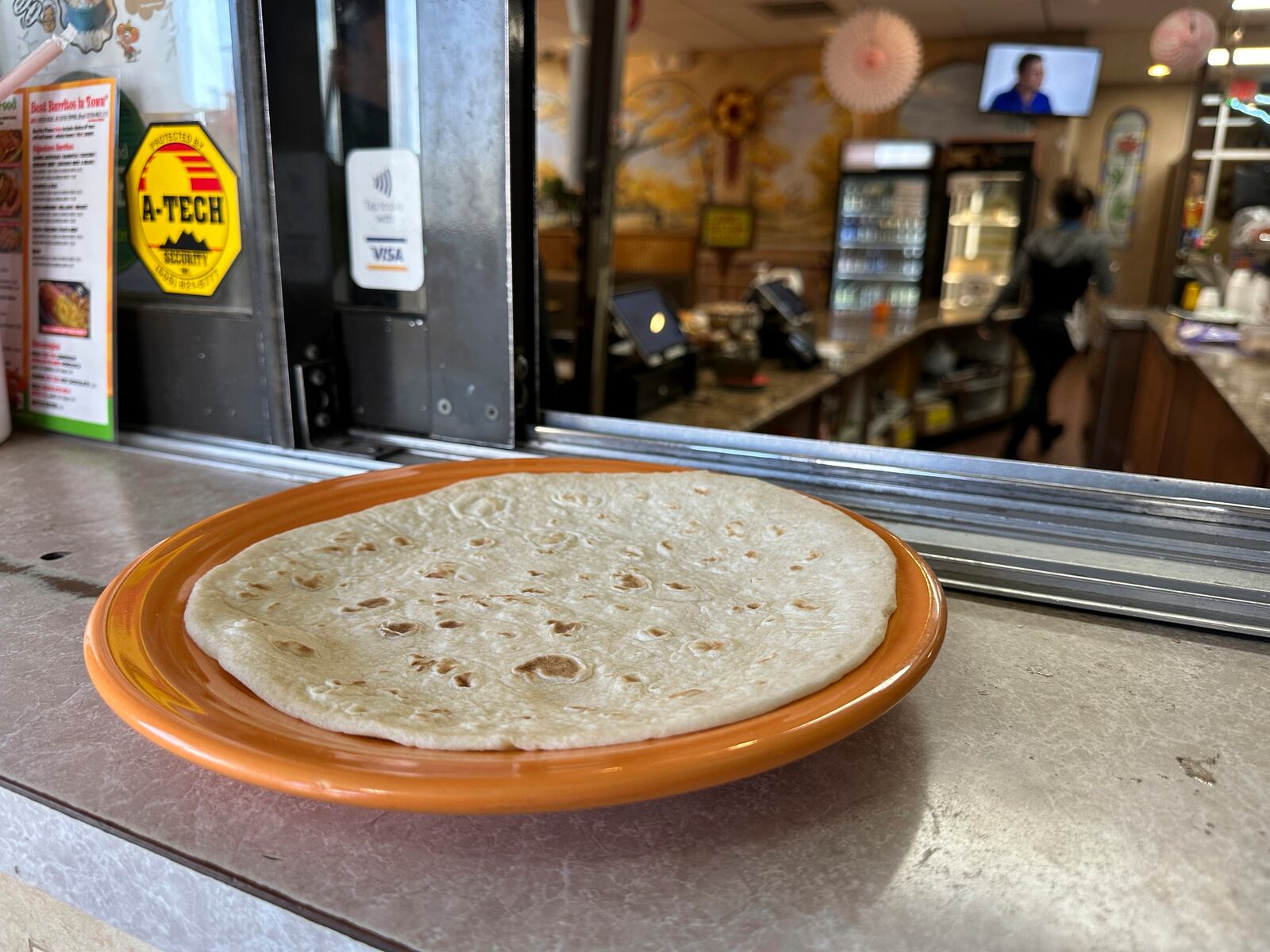 A fresh tortilla covers a large plate at Garcia's Kitchen in Albuquerque, New Mexico, on Thursday, April 10, 2025. (AP Photo/Susan Montoya Bryan)