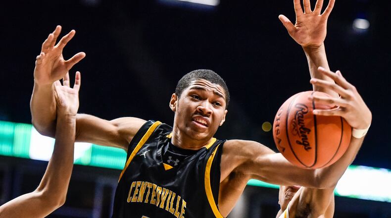 Centerville’s Mo Njie, left, fights for a rebound with Springfield’s RaHeim Moss during their Division I regional boys basketball semifinal Wednesday, March 13 at Xavier University’s Cintas Center in Cincinnati. Centerville won 67-63. NICK GRAHAM/STAFF