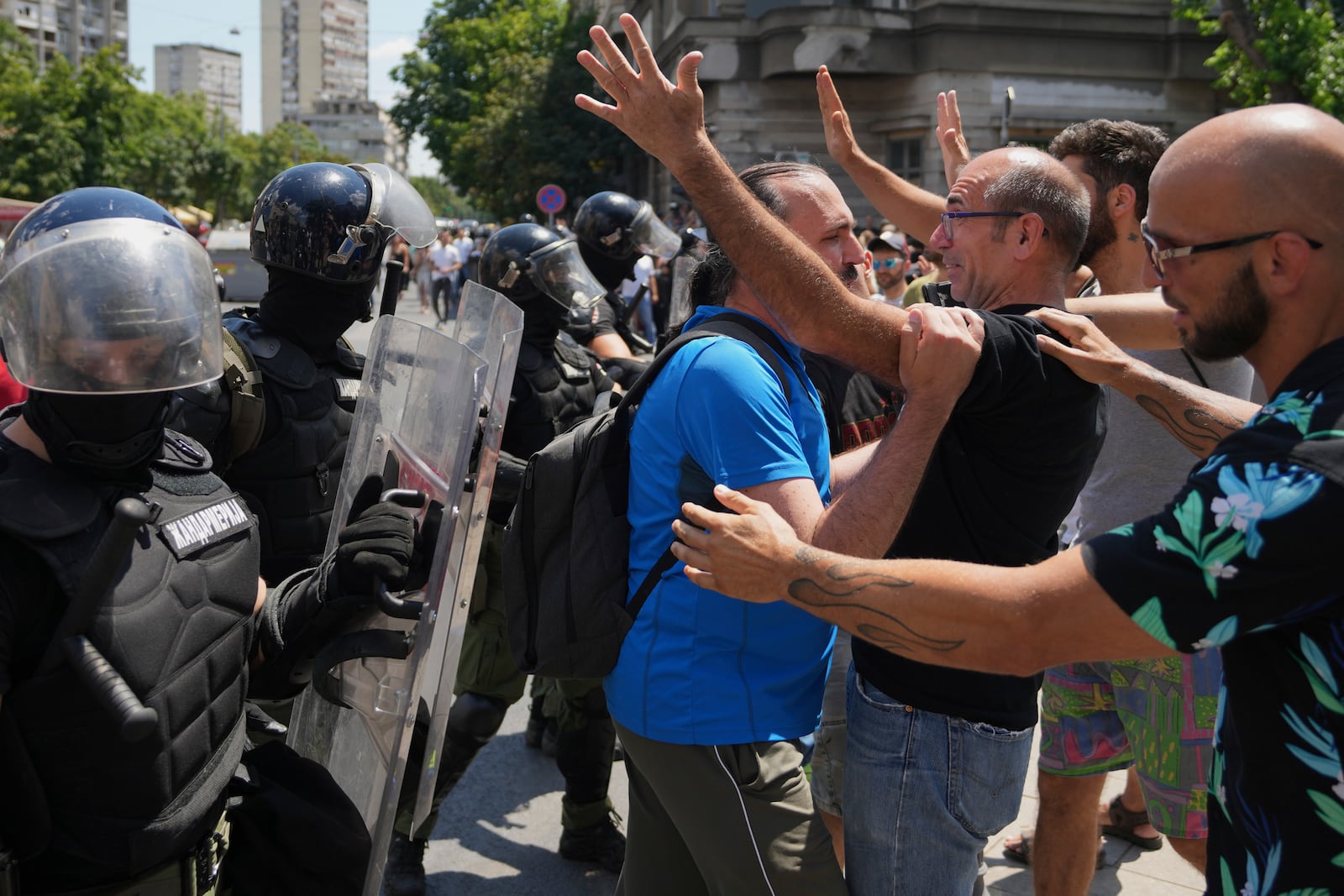 People react as Serbian gendarmerie officers remove a street blockade that was set up as part of a protest over a spate of arrests of anti-government protesters after a massive rally demanding an early parliamentary election in Belgrade, Serbia, Monday, June 30, 2025. (AP Photo/Darko Vojinovic)