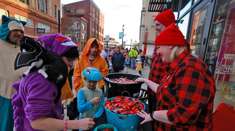 Hundreds of creepy and cute characters filled the sidewalks and streets in downtown Springfield for the seventh annual Downtown Springfield Trick or Treat Friday, Oct. 25, 2024. Downtown merchants, community organizations and nonprofits passed out candy, Halloween characters roamed the sidewalks and danced in the street. BILL LACKEY/STAFF
