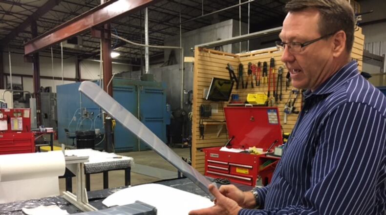 Craig Jennings, Spintech president, explains the compay’s “shape memory” polymer material. THOMAS GNAU/STAFF