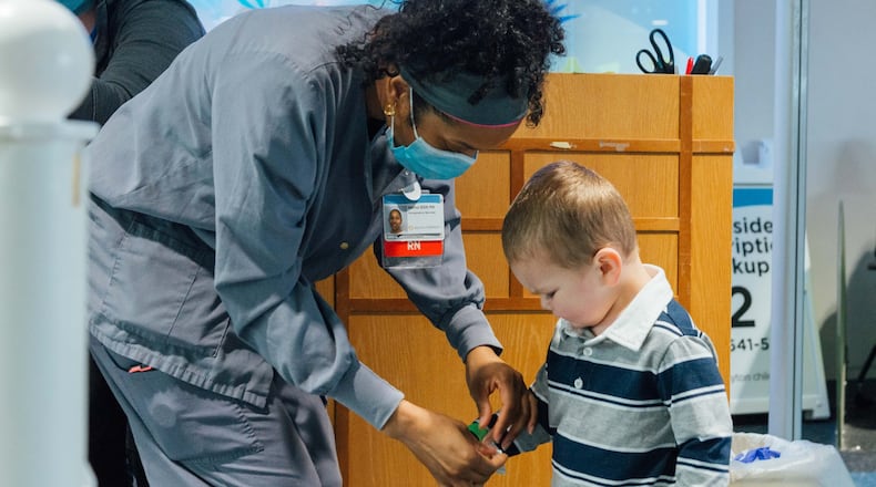 A nurse at the Dayton Children’s Hospital screens a young visitor for COVID-19 before he’s allowed to enter the facility on a recent afternoon. Dayton Children’s and other hospitals in the region require that anyone who enters their facilities be screened for the virus. CONTRIBUTED
