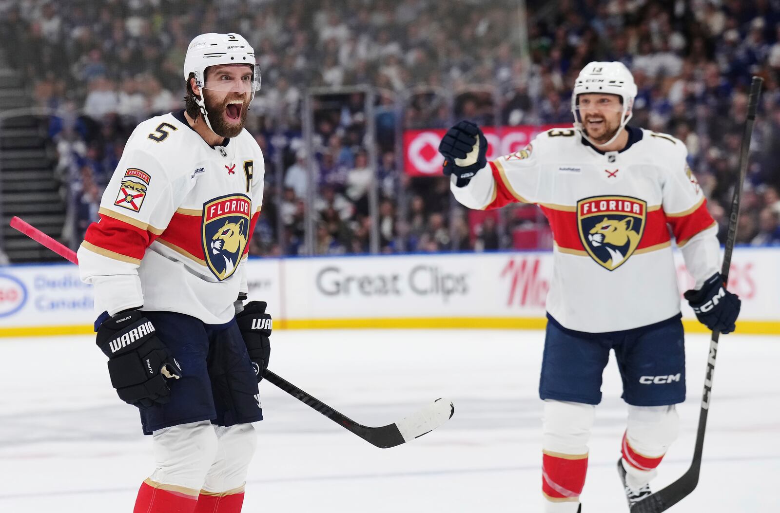 Florida Panthers' Aaron Ekblad (5) celebrates his goal against the Toronto Maple Leafs with Sam Reinhart (13) during first period NHL playoff hockey action in Toronto on Wednesday, May 14, 2025. (Nathan Denette/The Canadian Press via AP)