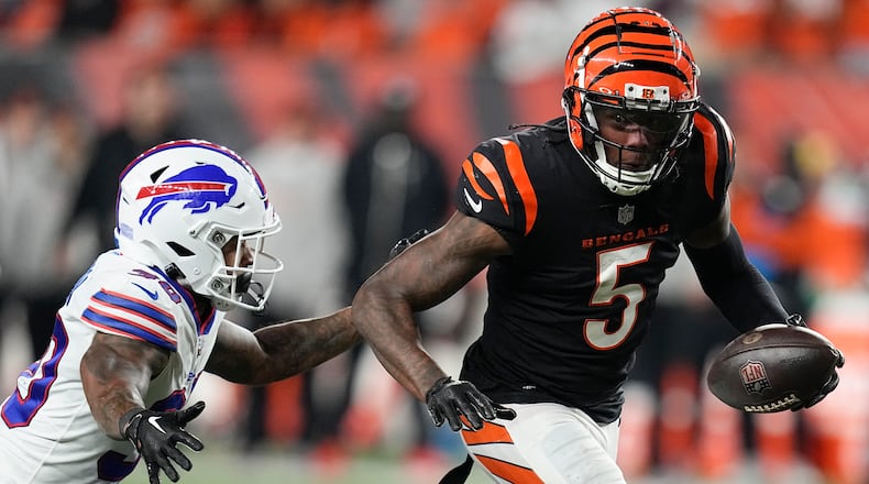 Cincinnati Bengals wide receiver Tee Higgins (5) runs with the ball as Buffalo Bills cornerback Dane Jackson tries to stop him during the second half of an NFL football game, Sunday, Nov. 5, 2023, in Cincinnati. (AP Photo/Darron Cummings)