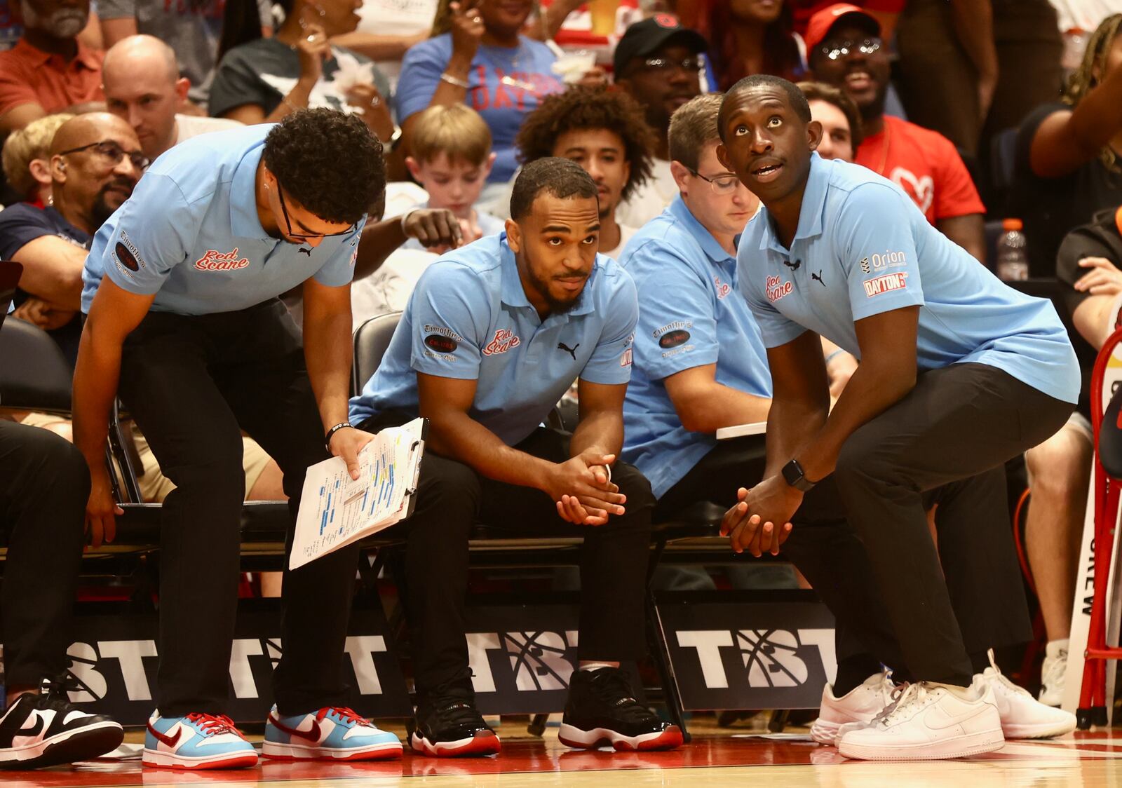 Red Scare coaches, including Jordan Harbeck, left, Camron Greer, center, and Jeremiah Bonsu talk during a game against Carmen's Crew in the second round of The Basketball Tournament on Monday, July 22, 2024, at UD Arena. David Jablonski/Staff