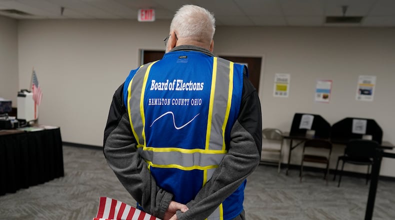Poll worker Paul Sharp stands by to help voters during early in-person voting at the Hamilton County Board of Elections in Cincinnati, Wednesday, Oct. 11, 2023. (AP Photo/Carolyn Kaster)