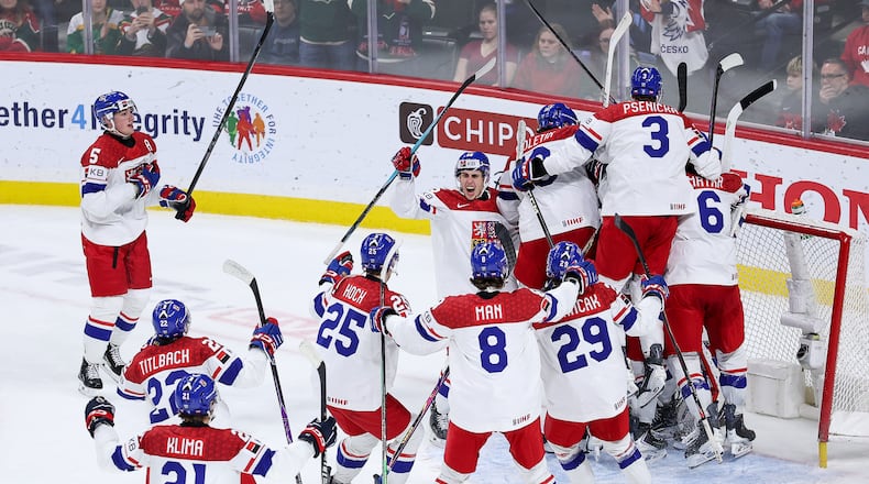 Czechia players celebrate their teams win during the third period of an IIHF World Junior Hockey Championship semifinals game against Canada, Sunday, Jan. 4, 2026, in St. Paul, Minn. (AP Photo/Matt Krohn)