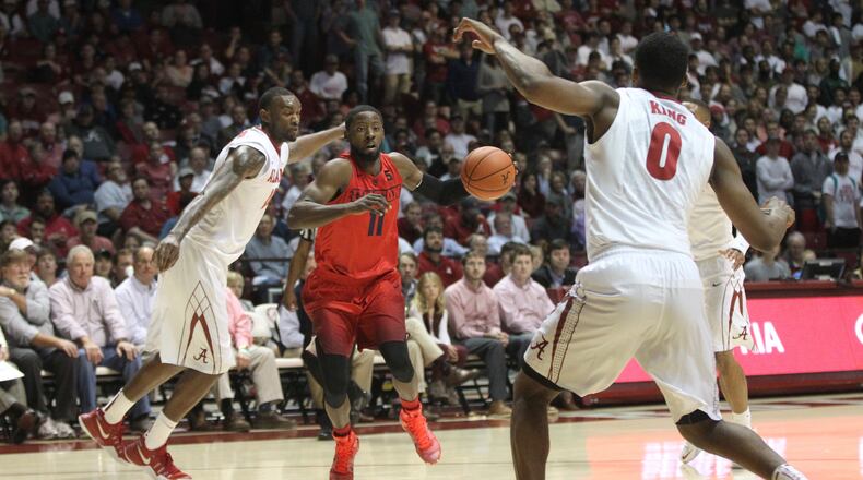 Scoochie Smith drives to the basket in the first half. David Jablonski/Staff