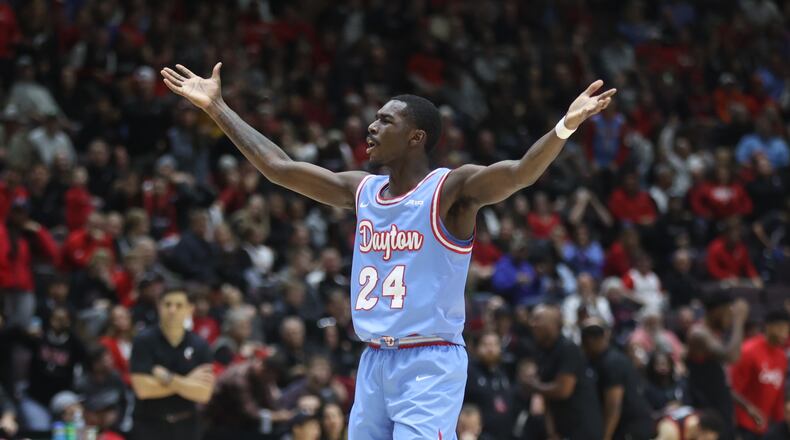 Dayton's Kobe Elvis celebrates in the second half against Cincinnati on Saturday, Dec. 16, 2023, at the Heritage Bank Center in Cincinnati. David Jablonski/Staff