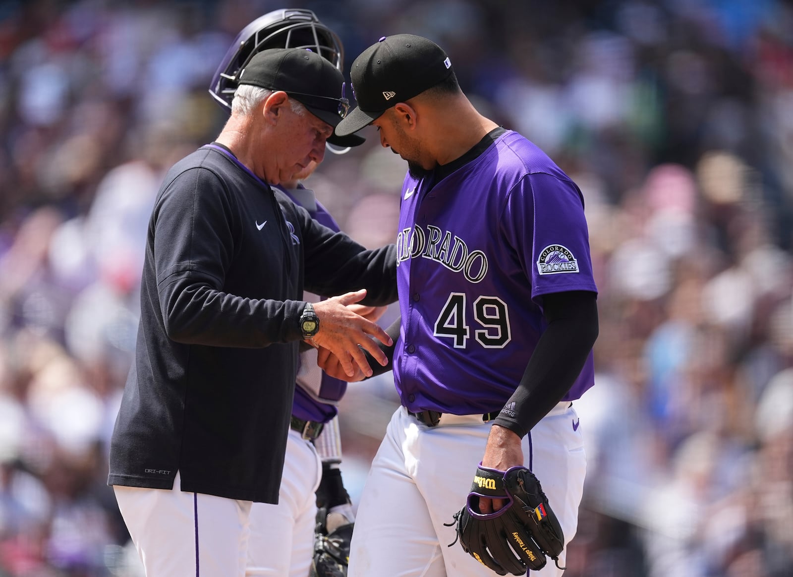Colorado Rockies manager Bud Black, left, takes the ball from starting pitcher Antonio Senzatela as he is pulled form the mound after giving up a single to Cincinnati Reds' Gavin Lux in the sixth inning of a baseball game Saturday, April 26, 2025, in Denver. (AP Photo/David Zalubowski)