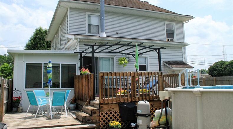 Off the kitchen is a 2-level 4-season room with a wood-burning stove and bench seat storage. The room opens to the multi-level deck and private back yard.