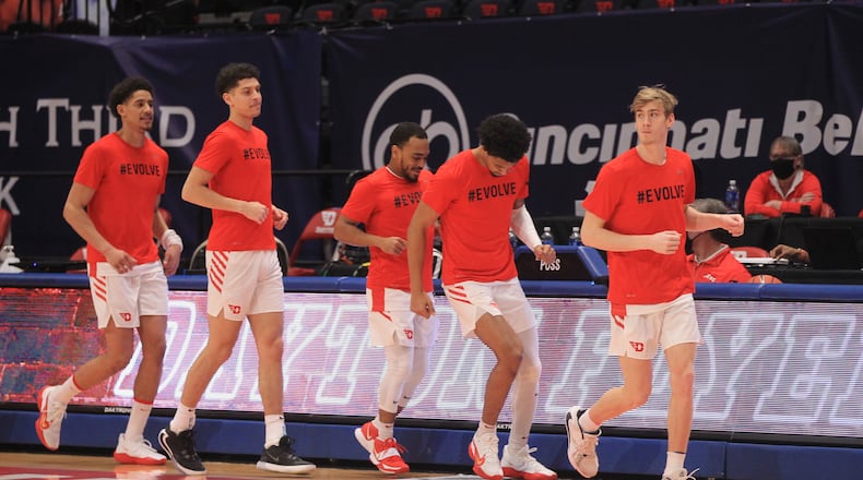 Dayton players, including Luke Frazier, right, take the court before a game against Virginia Commonwealth on Tuesday, Feb. 9, 2021, at UD Arena in Dayton. David Jablonski/