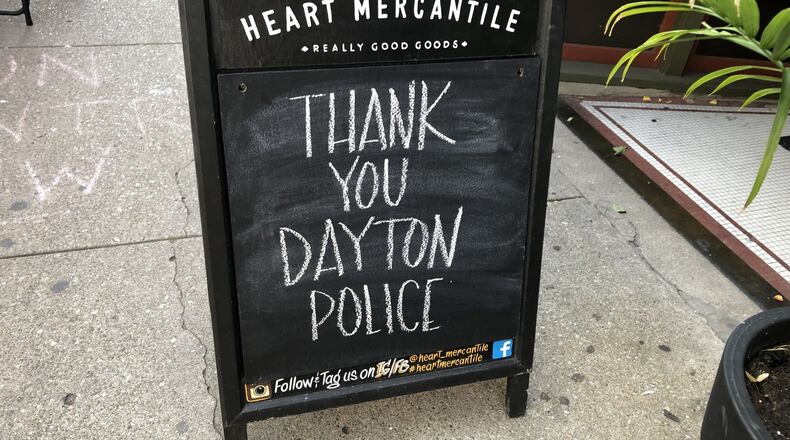 Signs were posted all over the city thanking Dayton police after the Aug. 4 mass shooting in the Oregon District. CORNELIUS FROLIK / STAFF