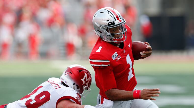Ohio State quarterback Justin Fields, right, cuts upfield on his way to a touchdown against Miami (Ohio) defensive back Bart Baratti during the first half of an NCAA college football game Saturday, Sept. 21, 2019, in Columbus, Ohio. (AP Photo/Jay LaPrete)