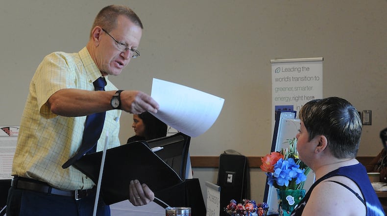 Scott Griggs hands his resume to Penny Darst, the director of recruitment for Addison Healthcare Professionals, Thursday July 7, 2022 at the Exploring Careers in Manufacturing and Technology Hiring Event at the Trotwood Branch Library. Sinclair Community College and Dayton Metro Library partnered to put on the event. MARSHALL GORBY\STAFF