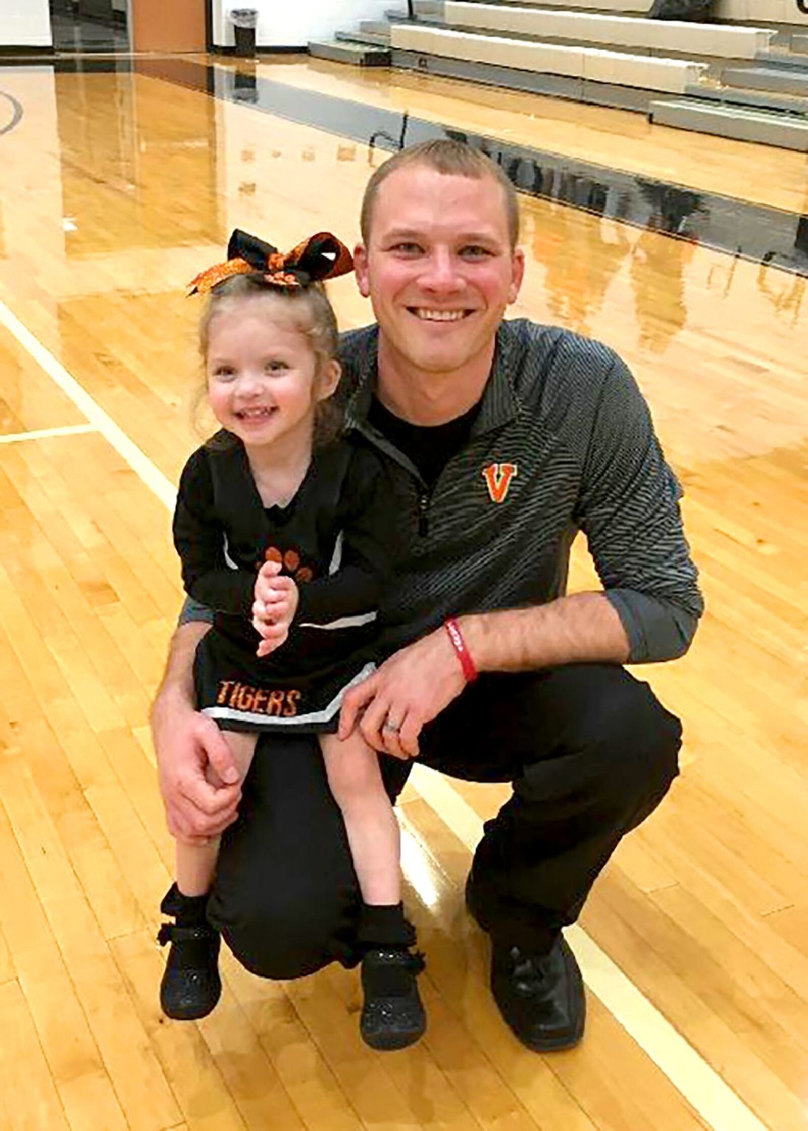 Two-year-old Samie Swank with her dad Travis after a Versailles High School game against Anna earlier this season. Travis is the first-year head coach of the No. 3 ranked, Division III Tigers. Samie was born with a heart condition that has resulted in many painful operations. In 2015 she was fitted with a pacemaker. CONTRIBUTED PHOTO