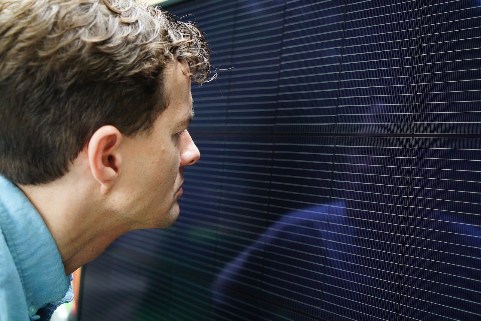 Will Etheridge, CEO of Southern Energy Management, looks at a solar panel that will be installed on James Asbill's home in Chapel Hill, N.C., Wednesday, July 2, 2025. (AP Photo/Allen G. Breed)