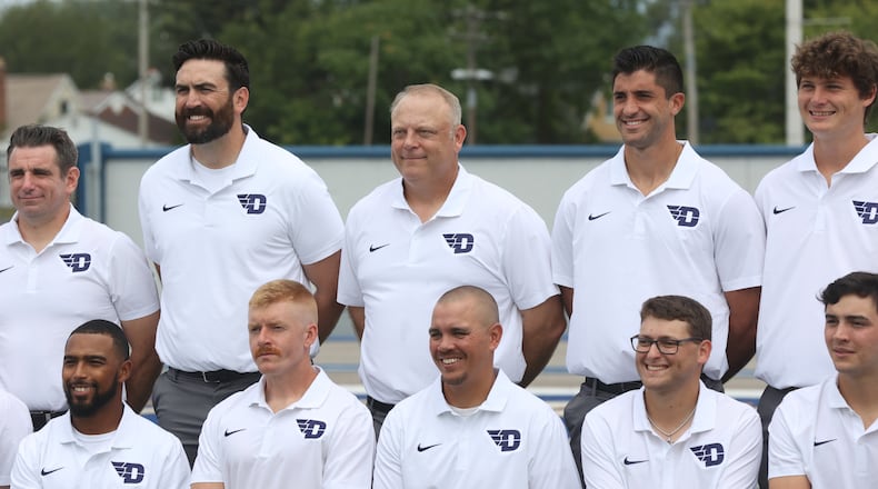Dayton football coach Trevor Andrews, center, poses for a photo with his staff during the team photo on on media day on Sunday, Aug. 18, 2024, at Welcome Stadium. David Jablonski/Staff