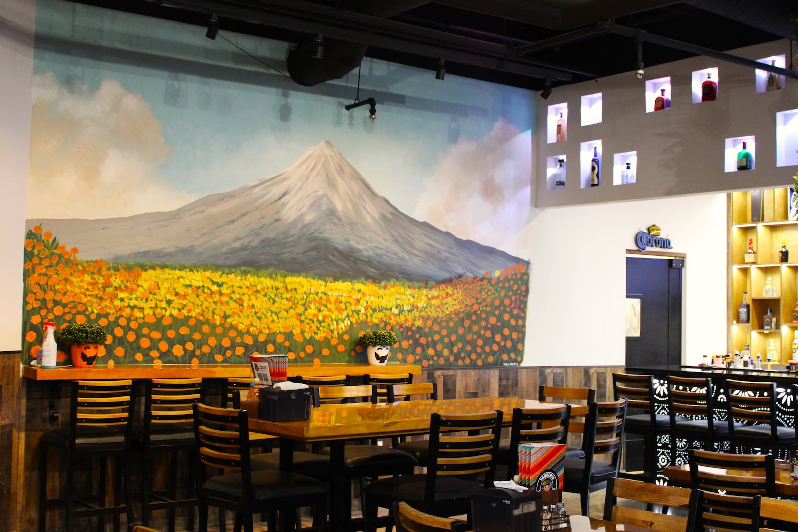 Customers walking into the dining area of La Poblanita are greeted by a large mural of Popocatépetl, an active volcano in Puebla, Mexico.
