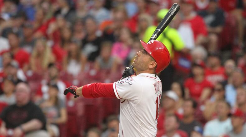 The Reds' Joey Votto hits a grand slam in the third inning against the Tigers on Tuesday, June 19, 2018, at Great American Ball Park in Cincinnati.