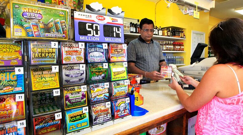 Ohioans spent more in 2015 playing the state lottery than residents of other states with lotteries, according to a study. Bob Patel (left) sells a Lottery ticket to a customer at the Kwik & Kold off Ohio 4 in Liberty Twp. The store is one of the top Lottery agents in Butler County. In 2011, the store sold the most winning tickets in Butler County.