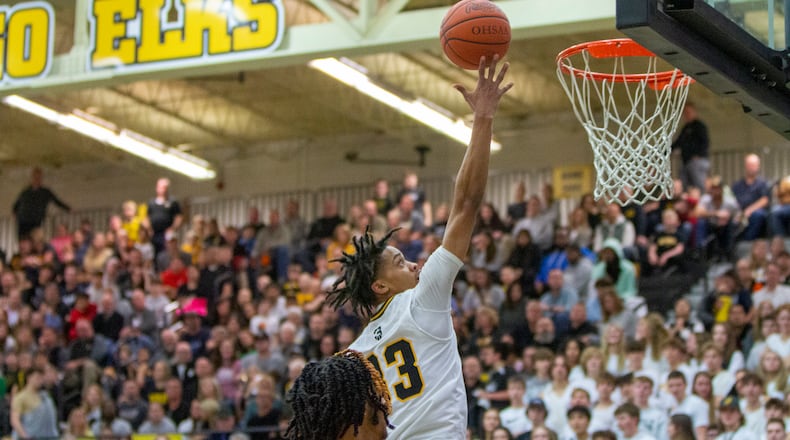 Centerville's Jonathan Powell scores two of his 22 points during Friday night's 84-56 victory over visiting Wayne. CONTRIBUTED/Jeff Gilbert