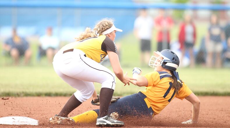 Kenton Ridge’s Lexee Trainer tags out Monroe’s Faith Hensley in a Division II district final on Sunday, May 20, 2018, at Brookville High School. David Jablonski/Staff