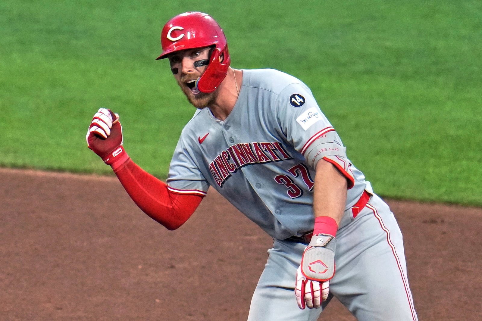 Cincinnati Reds' Tyler Stephenson celebrates as he stands on second base after hitting a double off Pittsburgh Pirates pitcher Dauri Moreta, driving in a run, during the sixth inning of a baseball game in Pittsburgh, Friday, Aug. 8, 2025. (AP Photo/Gene J. Puskar)
